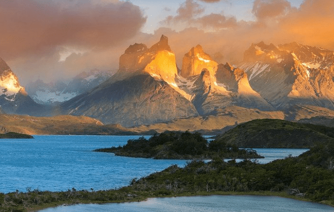 Mountain range with a lake at sunset.