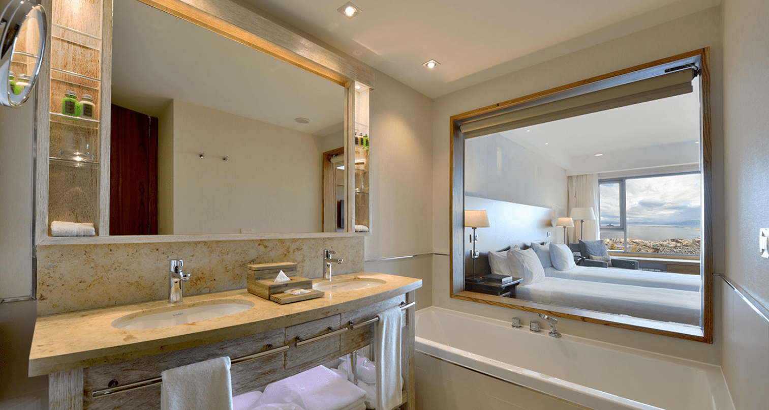 Modern bathroom with bathtub and ocean view.