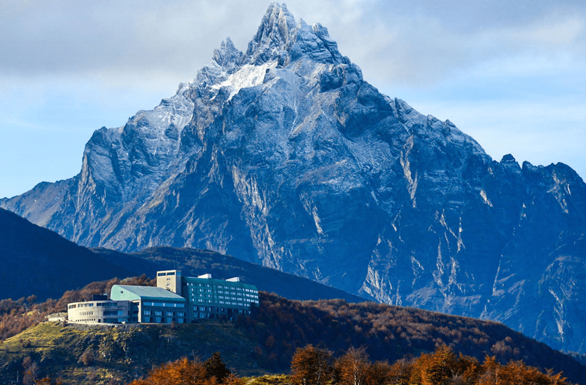 A mountain with snow and a hotel.