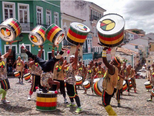 Drummers in colorful costumes playing music.