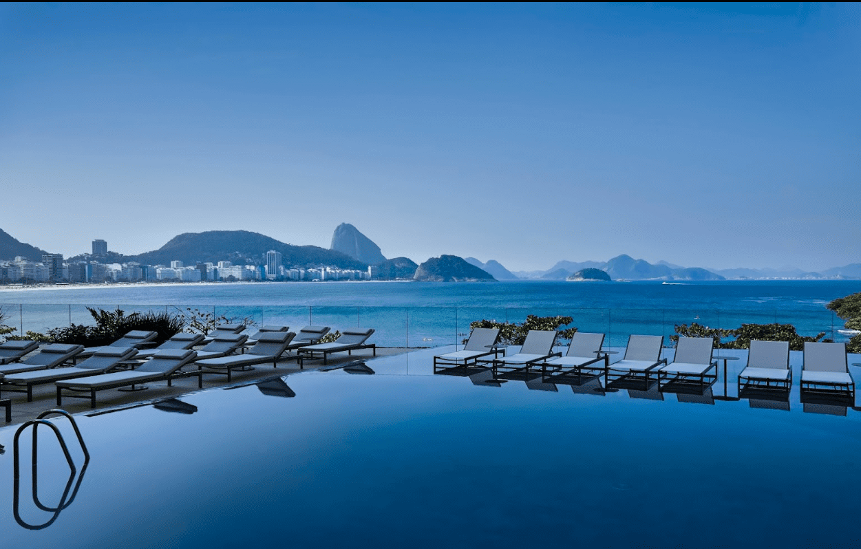 Infinity pool overlooking ocean and mountains.