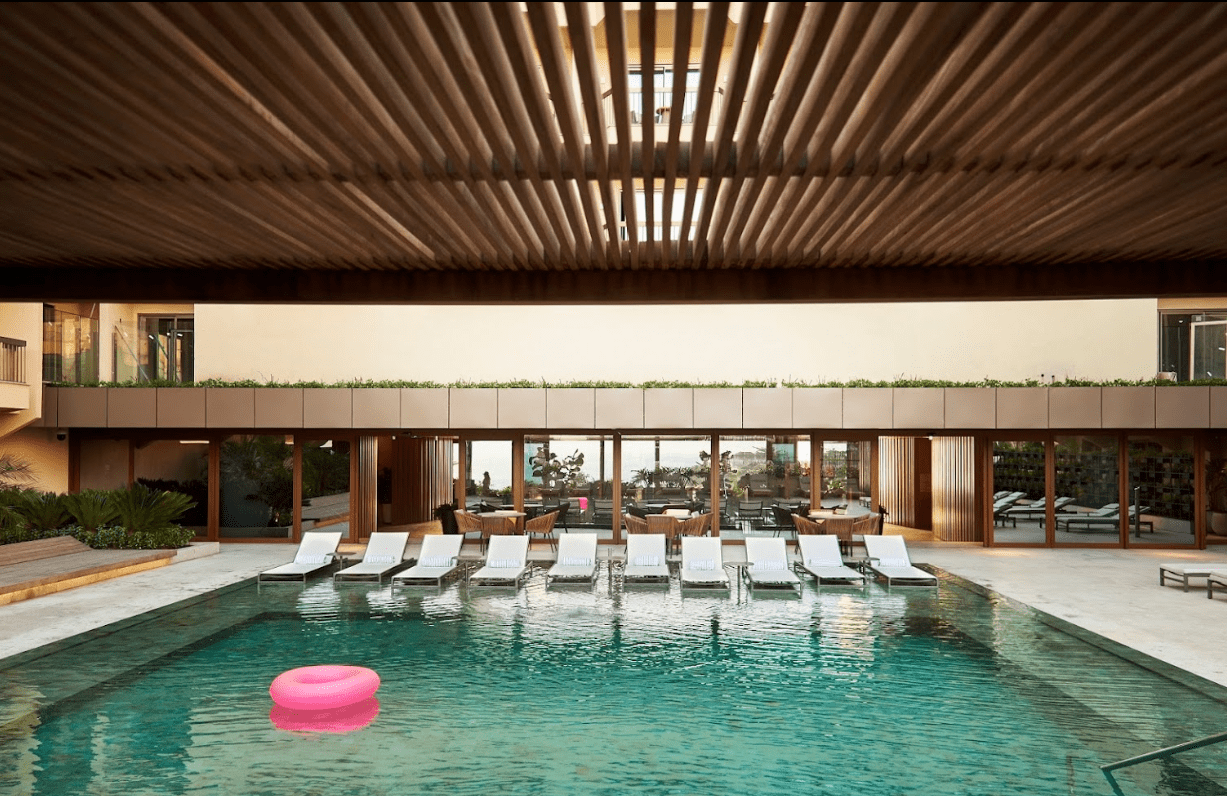 Pool with lounge chairs and a pink float.