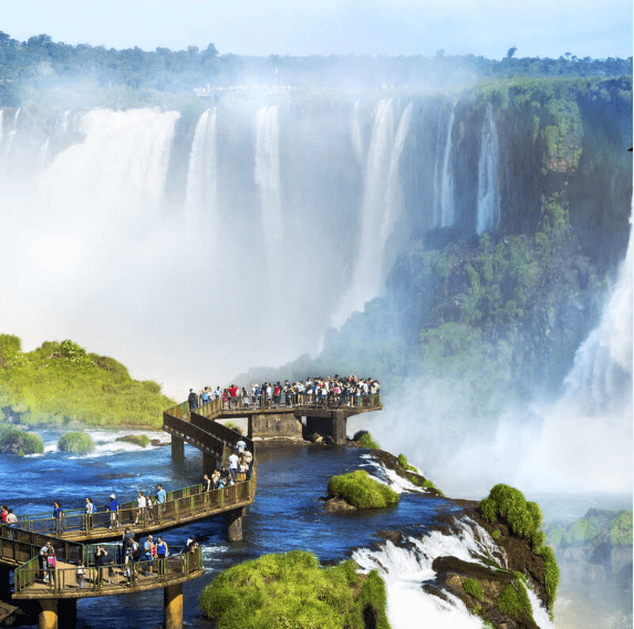 Tourists on a bridge overlooking Iguazu Falls.