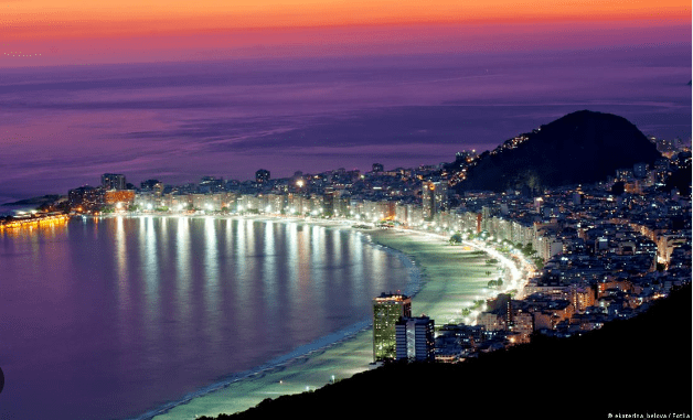 Night view of a city by the beach.