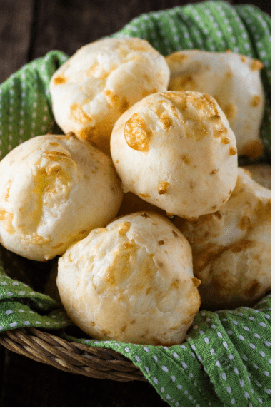 Cheesy bread rolls in a basket.