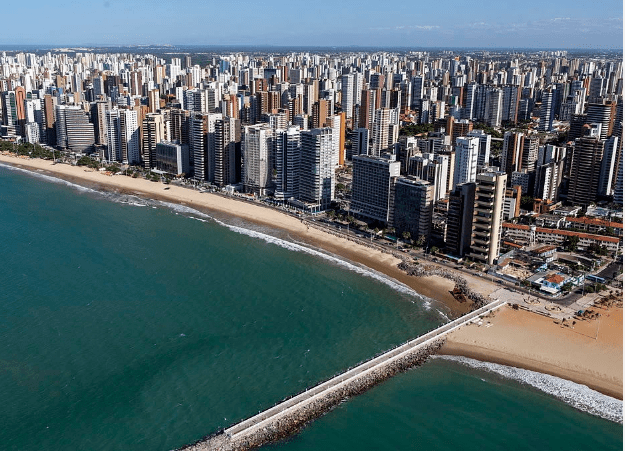 Aerial view of a coastal city with a pier.