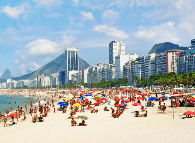 Crowded beach with colorful umbrellas in Rio.