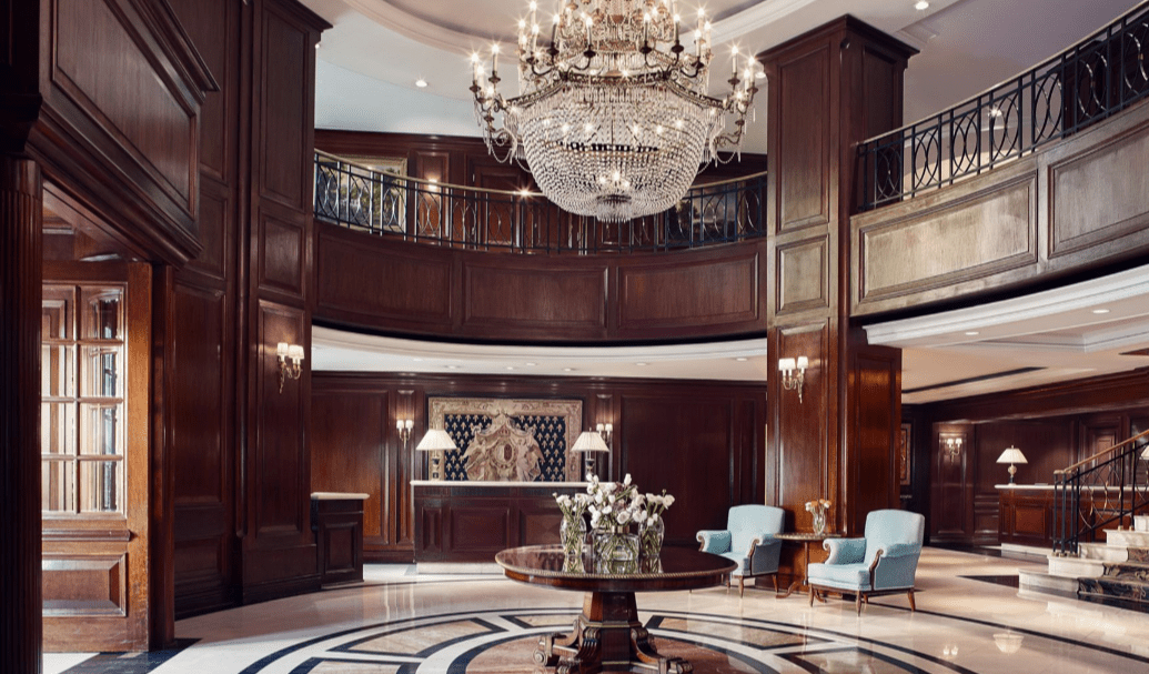 Luxury hotel lobby with grand chandelier.