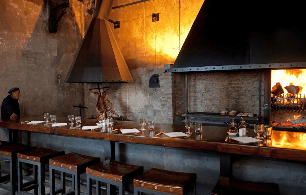 Restaurant interior with fireplace and grill.