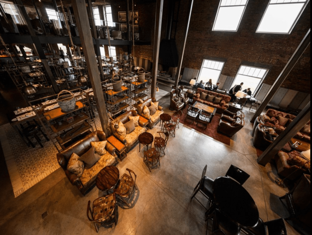 Industrial loft restaurant interior with seating.