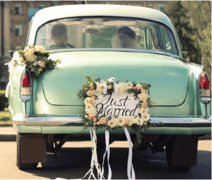 Vintage green car with "Just Married" sign.