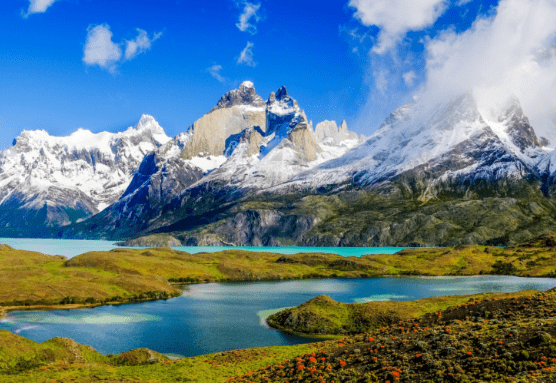 Mountain lake scene with snowcapped peaks.