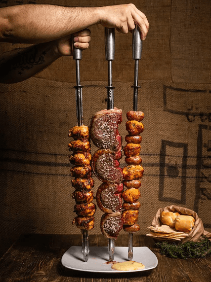 Grilled meat and onions on skewers.