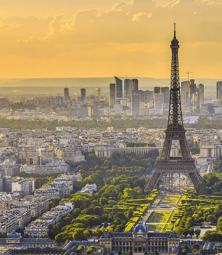 Eiffel Tower overlooking Paris skyline at sunset.