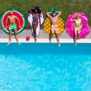 Men and women sunbathing near the pool