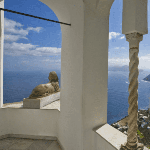 A view from the top of a building overlooking the ocean.