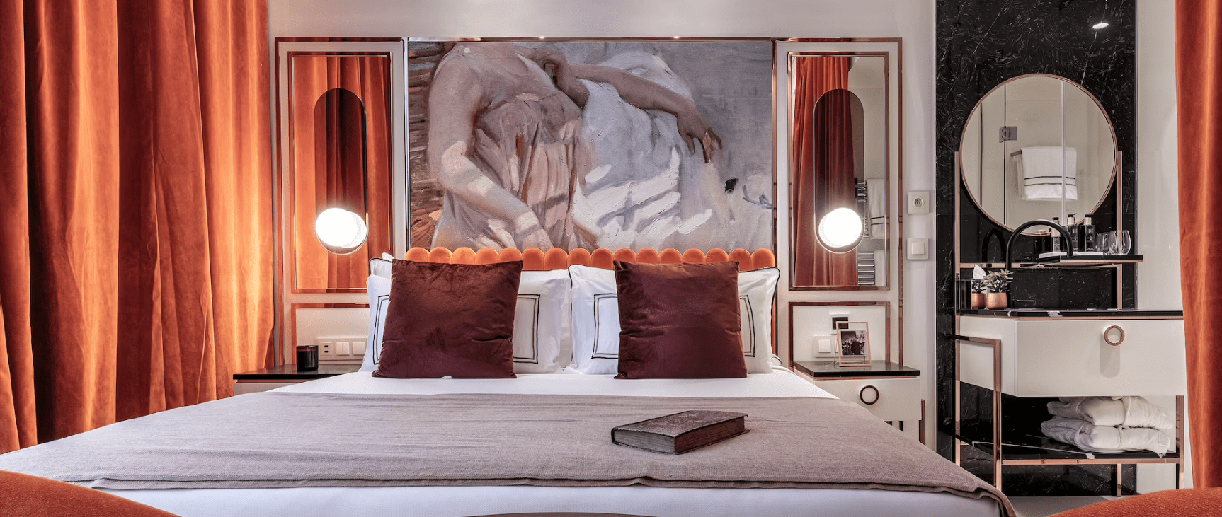 Elegant bedroom with art deco decor and a book.