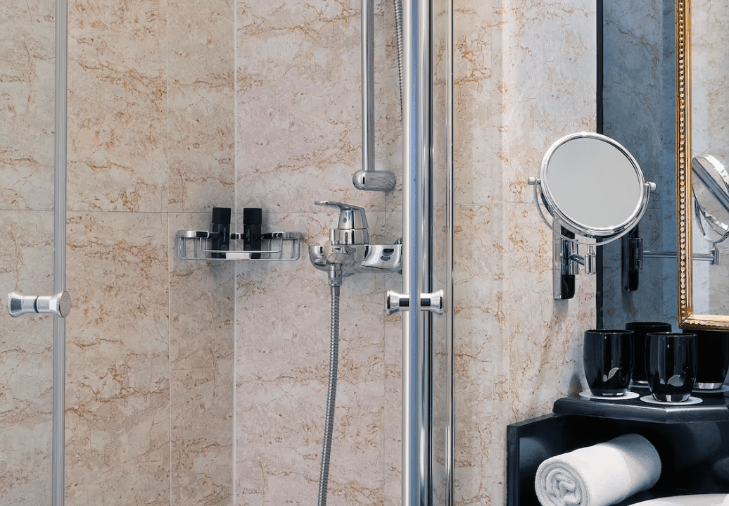 Modern bathroom with shower and mirror.