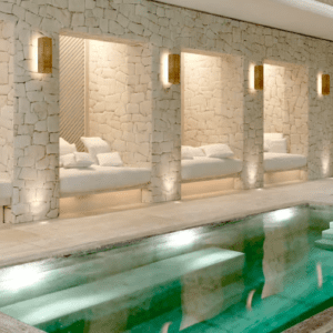 A spa room with a large swimming pool.