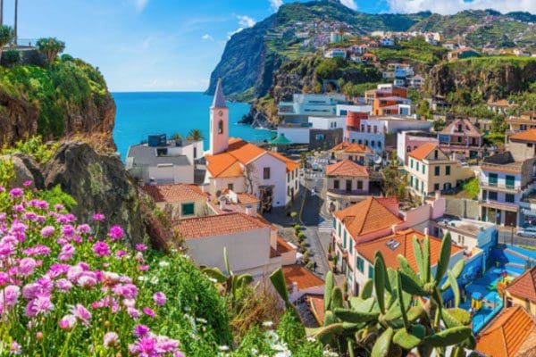 Coastal town with colorful buildings and ocean view.