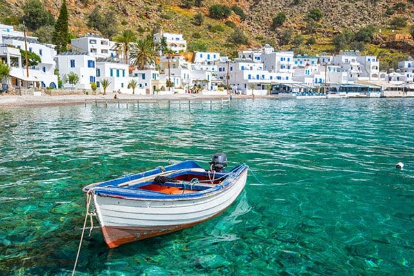 Small boat moored in turquoise water.