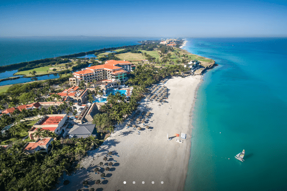 Aerial view of resort on a beach.