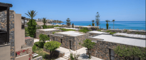 An aerial view of a resort with a view of the sea.