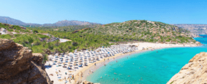 A beach on a cliff overlooking the water.