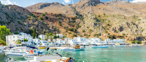 A harbor with boats and mountains in the background.