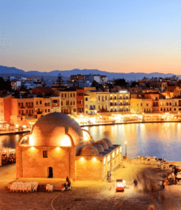 A view of a town at dusk in crete, greece.