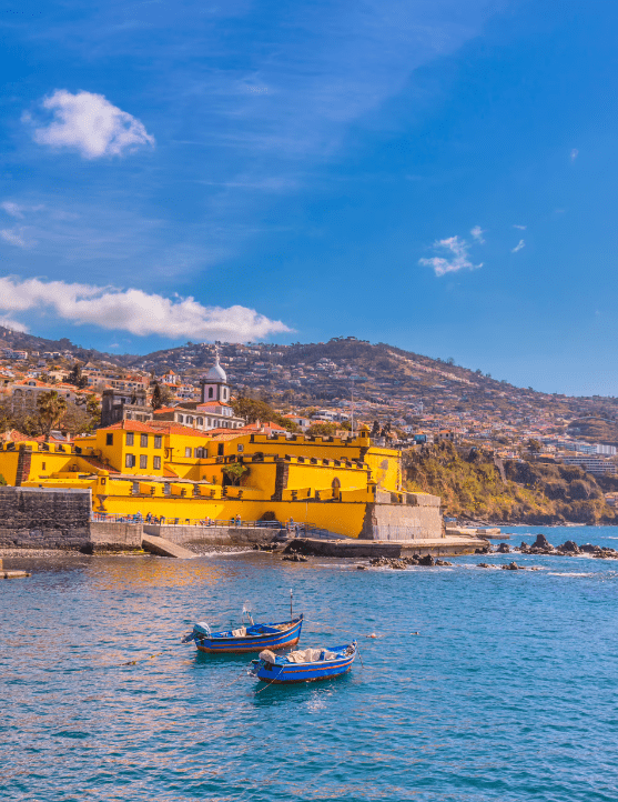 Yellow building on waterfront with boats.