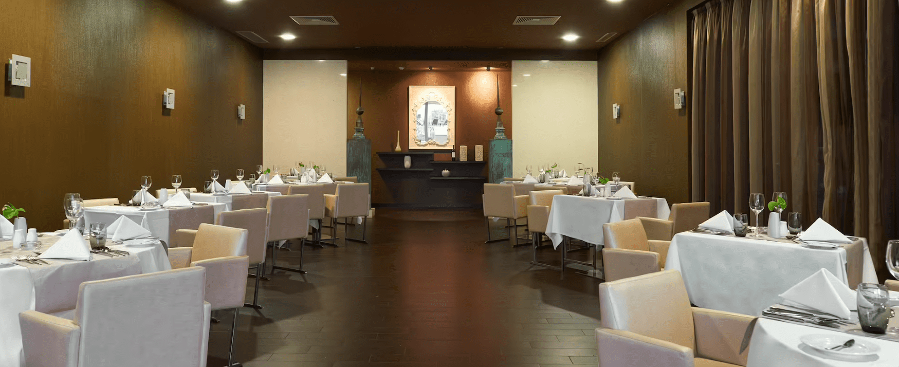 A restaurant with tables and chairs set up.