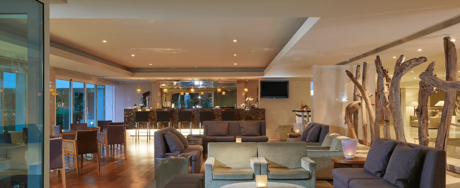 A wooden floor in the room with table and chairs.