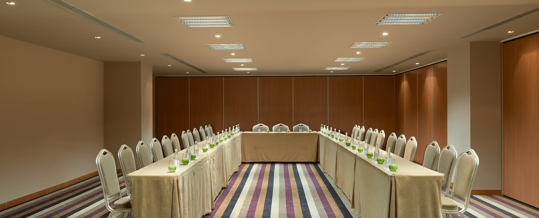 A conference room with a long table and chairs.