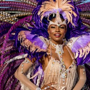 A woman in a purple and purple costume posing for a photo.