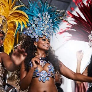 A group of women in feathered costumes at a carnival.