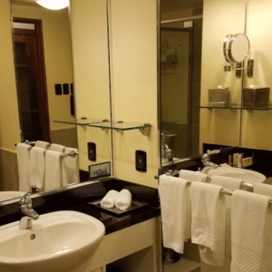 A bathroom with two sinks and a mirror.