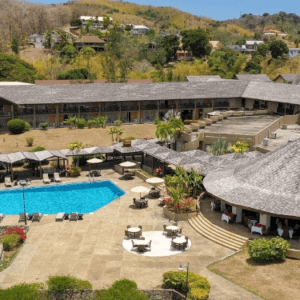 An aerial view of a resort with a swimming pool.