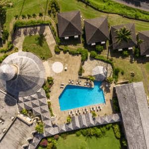 An aerial view of a resort with a swimming pool.