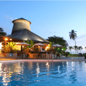 A resort with a swimming pool at dusk.