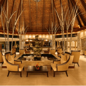 The lobby of a hotel with a wooden ceiling.