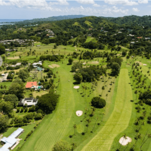 An aerial view of a golf course near the ocean.