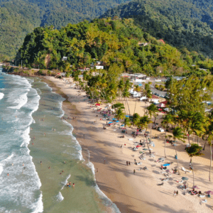 An aerial view of a beach with a lot of people on it.