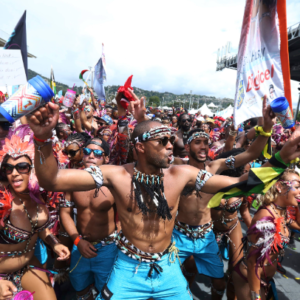 A group of people dressed in colorful costumes and holding flags.