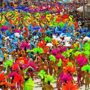 A group of people dressed in brightly colored costumes walking down a street.