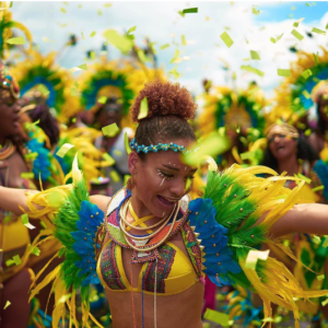 A woman in a brightly colored costume dances with confetti.