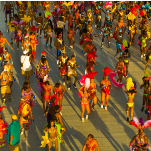 A group of people in colorful costumes walking down a street.