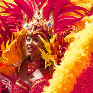 A woman in a red and yellow costume at a carnival.