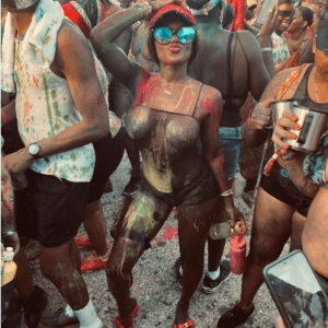 A group of people at a festival with paint on their faces.