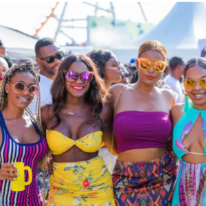 A group of women in bikinis posing for a photo.